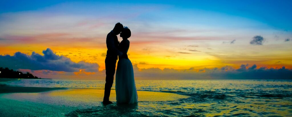 bahamas destination wedding featuring newlyweds on the beach at sunset