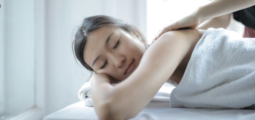 Woman receiving a luxury massage at an all-inclusive resort spa with premium services.
